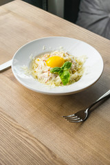Italian pasta, italian cousine, pasta carbonara, wooden background