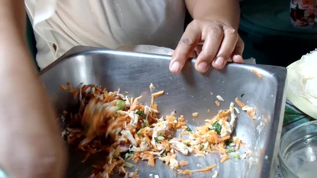 Wrapping up various vegetable lumpia rolls sorties in a dirty kitchen