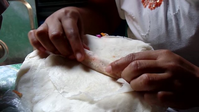 Wrapping up various vegetable lumpia rolls sorties in a dirty kitchen
