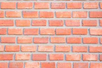Orange brick wall texture background. Brickwork or stonework flooring interior rock old pattern clean concrete grid uneven bricks design stack.
