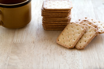 Milk cracker cookies Served with hot coffee on wooden desk ,Time break