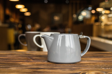 Hot tea with berries, wood background, teapot with tea, cosiness