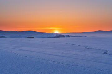 Panoramic frozen landscape in winter sunset at frozen lake Baikal in Siberia, Russia
