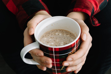 Woman's hands holding a cup of hot chocolate