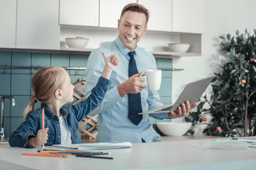 I did it. Satisfied pleasant creative looking at her father who staying near in the kitchen girl rejoicing and gesticulating.