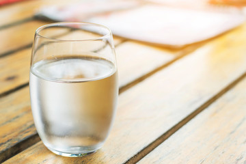 A glass of water on wooden table
