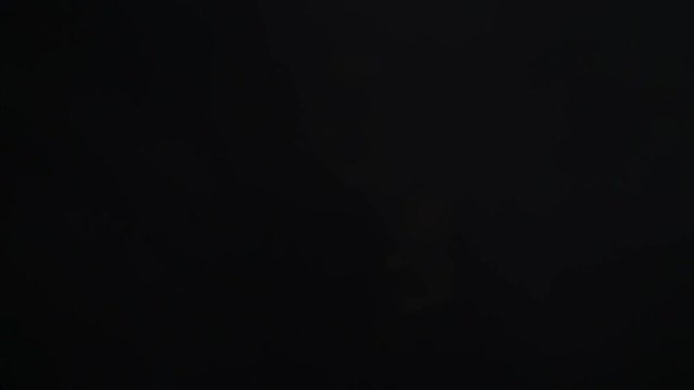 Smoke billowing on black background