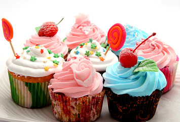 colorful cupcakes with pink frosting and sprinkles