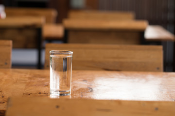 Glass of water on wooden desk