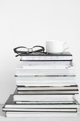 Cup of coffee on stack of books