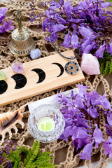 Witch Pagan Altar decorations with Moon Phases, crystals, flowers and pentacle