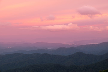 Fototapeta premium red color of sun and mountains layers during sunrise at Mea Kumpong, Thailand