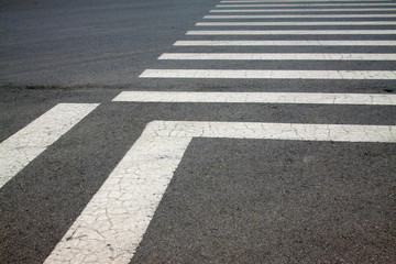 Fototapeta premium zebra crossing on asphalt pavement, closeup photo