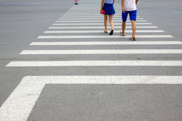 Pedestrians through the zebra crossing, closeup photo