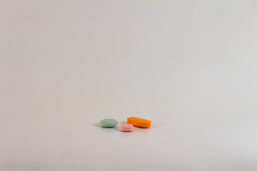 Drugs in the form of pills of different sizes, shapes and colors.