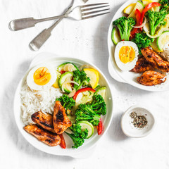 Healthy lunch - stewed vegetables, rice, boiled egg and teriyaki chicken on light background, top view