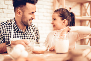 Girl with Man Pour Flour in Bowl Eggs on Table.