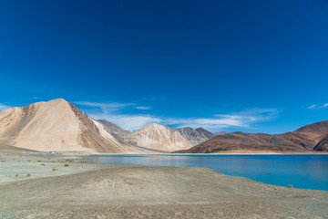 Landscape with lake, mountains and blue sky.