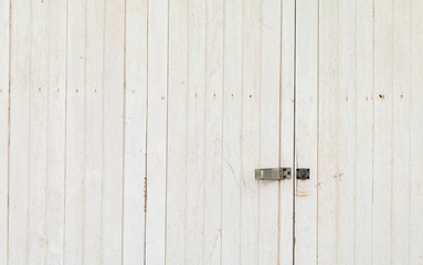 Metal old rusty door lock on white wooden door panel vintage background