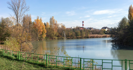 Fototapeta na wymiar Autumn in city park, river,sky.