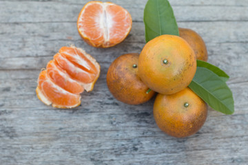 Closeup of fresh orange fruit on wooden table background