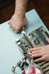 Repair motherboard. Male pliers removes the connector from the motherboard. Close-ups