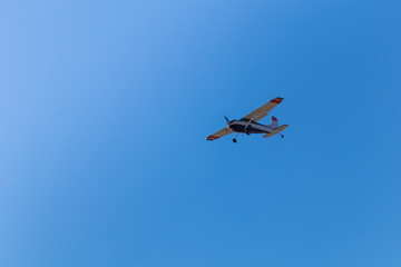 Small private plane flies low overhead