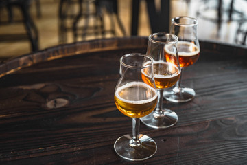 glass of beer on wooden barrel