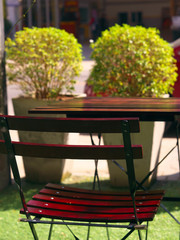 Wooden dining table and chair at green yard balcony in morning.