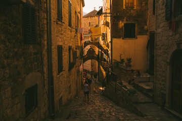 KOTOR, MONTENEGRO - July 19, 1990: tourists walking by tight kotor streets