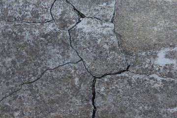 Old cement with cracks .