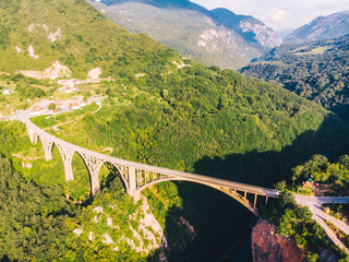 Fototapeta premium highway with high bridge cross canyon. aerial view