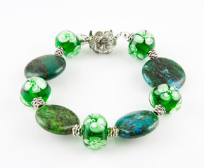 Collection of colorful glass beads, bracelets, pendant of different sizes and shapes. Colored Venetian, Murano glass, Silver glass, millefiori. Shot on a white background.