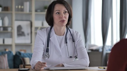 Old Lady Doctor Talking with Patient in Clinic