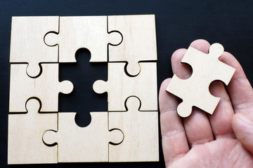 Man holding piece of puzzle. Solution problem with business.