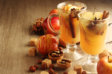 Two cups with hot cider in cold season with cinnamon and anise