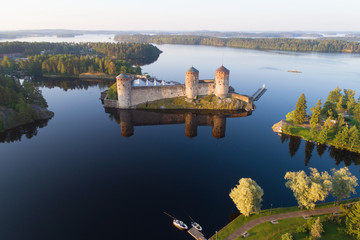 View of the Olavinlinna fortress in the Kuusalmi strait on a July morning (shooting from a quadcopter). Savonlinna, Finland © sikaraha