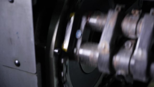 The work of a professional printing press in the printing house. The camera moves from right. Offset printing machine.