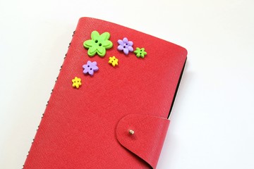 close up of  red notebook on white background