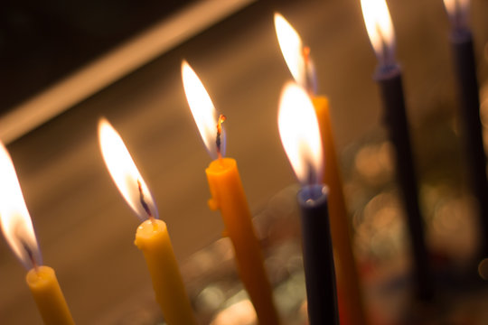 candle hanuka menora by window for jewish holiday