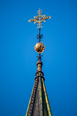 Fototapeta na wymiar Trondheim Church with their golden dome cross with a stunning blue sky at the background