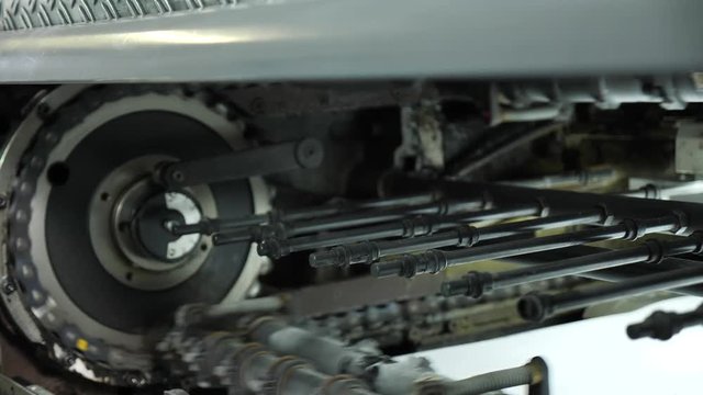 The work of a professional printing press in the printing house. The camera moves in slow motion. Offset printing machine.