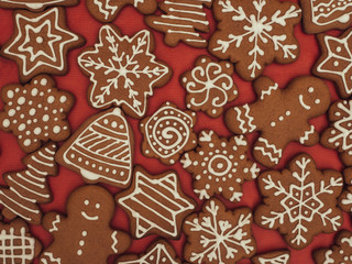 Happy New Year and Merry Christmas gingerbread on red background. Christmas baking. Making gingerbread christmas cookies. Christmas concept.