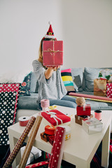 Woman preparing presents for family and friends for Christmas and New Year. Holiday concept.