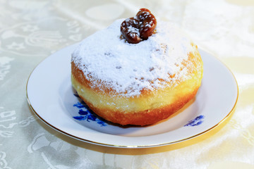 Hanukkah Sufganiyah (in Israel: Sufganiyot). Hanukkah (Chanukah) - Jewish Holiday. Sufganiyah - Festive Donut. Image of Jewish Holiday Hanukkah. Hebrew tablecloths inscriptions: Shalom
