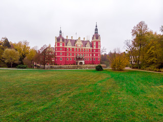 Fototapeta premium Wonderful picturesque Scene in the Park. Muskau Castle with sky in autumn. Schloss of Saxony, Germany. UNESCO World Heritage Site. Beautiful castle. 