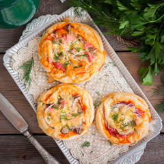 Mini pizza with sausage, top view, selective focus