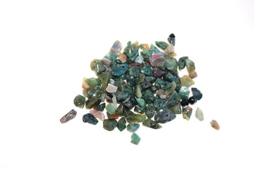 Green stone crumb for needlework on a white background. for making jewelry with their own hands. Interesting hobby. Creation.