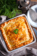 Puff pastry pie with chicken, potatoes and onions, quute pie, selective focus, top view