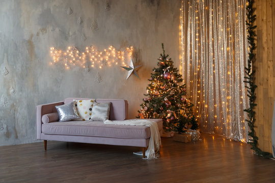 Dark loft living room decorated for Christmas with tree and lights